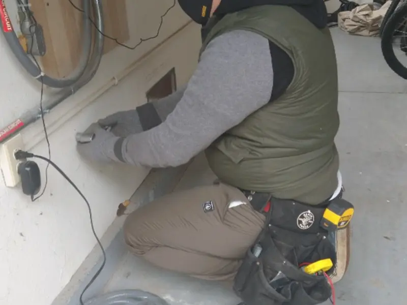 Electrician performing outlet wiring in a Spokane garage