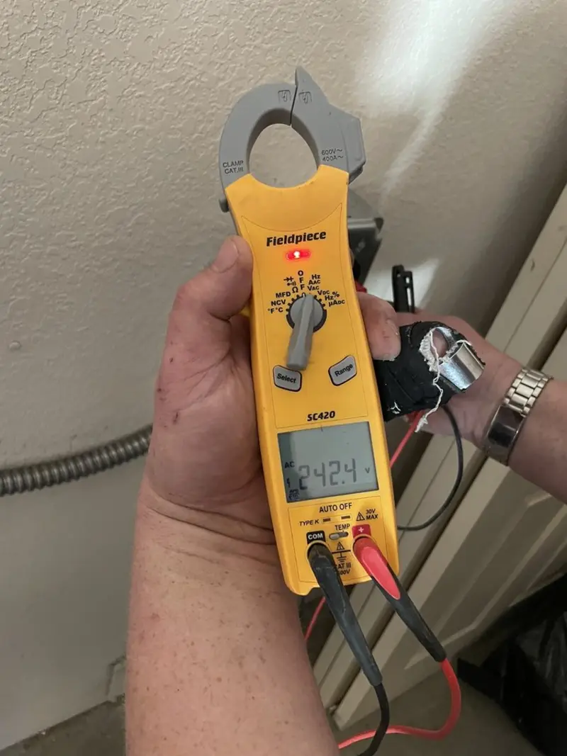 Voltage testing with clamp meter during Outlet Installation in Spokane